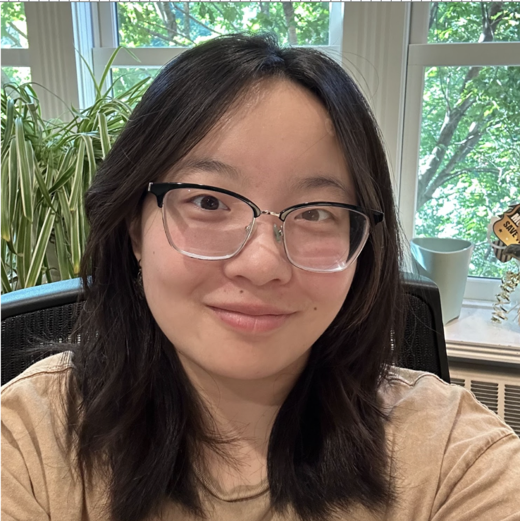 Viv Montgomery takes a selfie in the English department SW lounge with a backdrop of the bushy spider plant. 